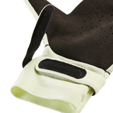 Close-up of a black and beige glove with a strap on a white background