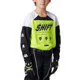 Kid wearing a black and white motocross shirt with bright green neon front Shift logo for mtb and MX dirt bike youth sports