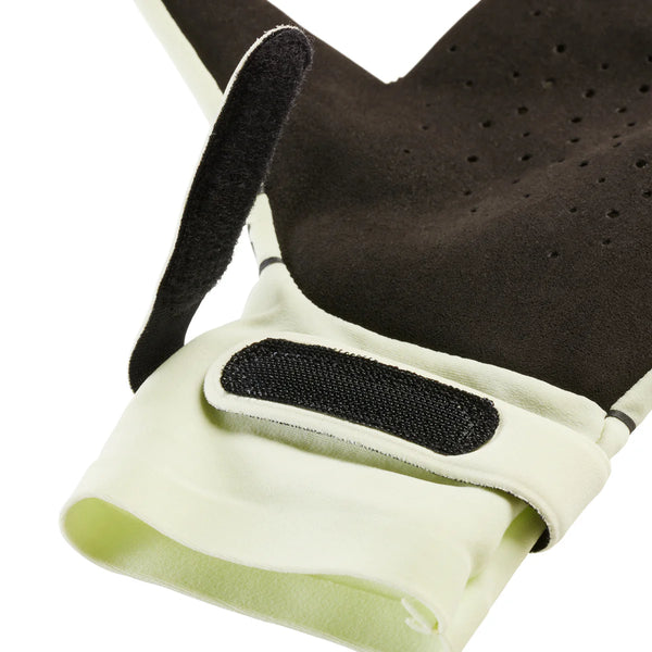 Close-up of a black and beige glove with a strap on a white background