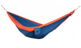 Ticket to the Moon Original Outdoor Hammock set up between trees in a park. Royal Blue Orange