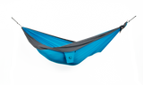 Ticket to the Moon Original Outdoor Hammock set up between trees in a park. Aqua Dark Grey