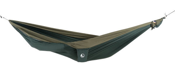 Ticket to the Moon Original Outdoor Hammock set up between trees in a park. Green Army