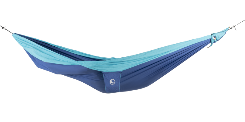 Ticket to the Moon Original Outdoor Hammock set up between trees in a park. Blue