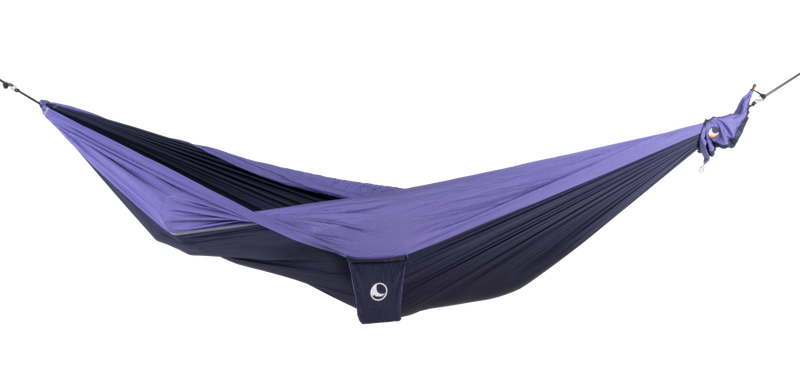 Ticket to the Moon Original Outdoor Hammock set up between trees in a park. Purple